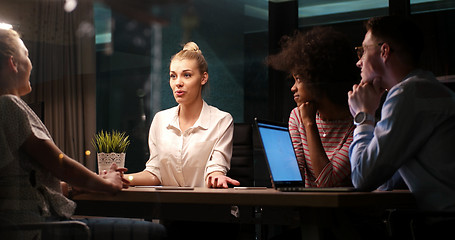 Image showing Multiethnic startup business team in night office