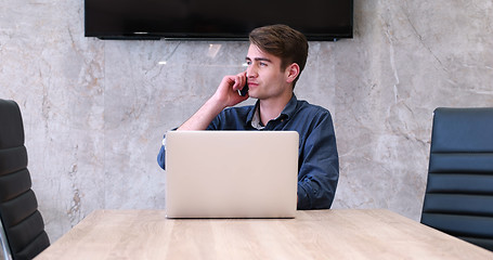 Image showing businessman working using a laptop in startup office