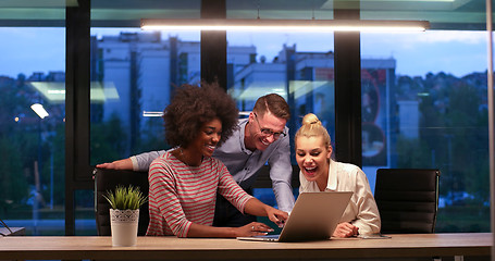 Image showing Multiethnic startup business team in night office