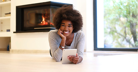 Image showing black women using tablet computer on the floor