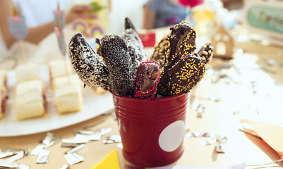 Image showing Girl birthday decorations. table setting from above with cakes, drinks and party gadgets.