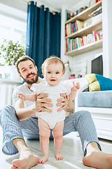 Image showing father and his baby daughter at home