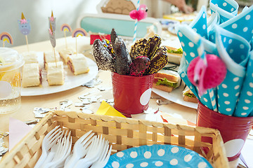 Image showing Girl birthday decorations. table setting from above with cakes, drinks and party gadgets.