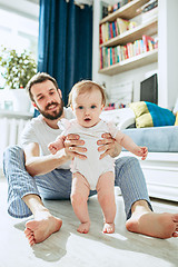 Image showing father and his baby daughter at home