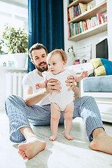 Image showing father and his baby daughter at home