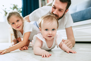 Image showing Proud father holding his newborn baby daughter at home