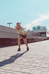 Image showing Pretty sporty woman jogging at city