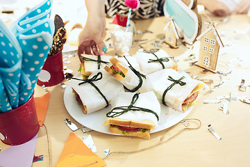 Image showing Girl birthday decorations. table setting from above with cakes, drinks and party gadgets.