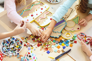 Image showing mosaic puzzle art for kids, children\'s creative game. two sisters are playing mosaic