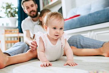 Image showing Proud father holding his newborn baby daughter at home