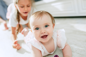 Image showing adorable two sisters at bedroom