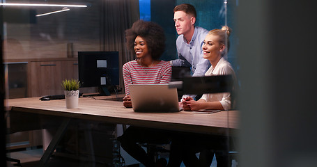 Image showing Multiethnic startup business team in night office