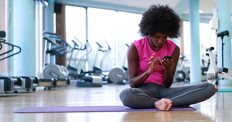 Image showing portrait of young afro american woman in gym on workout break