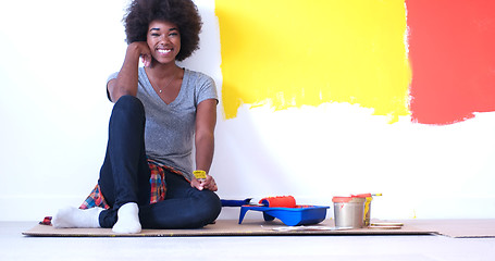 Image showing black female painter sitting on floor