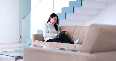 Image showing asian woman using Digital Tablet on sofa