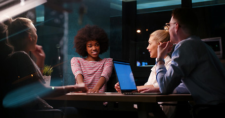 Image showing Multiethnic startup business team in night office