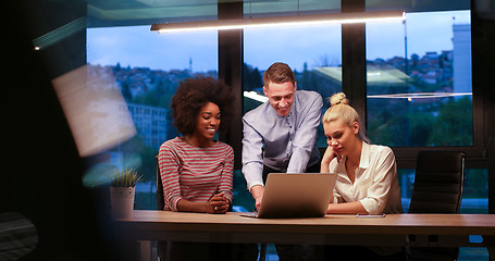 Image showing Multiethnic startup business team in night office