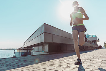 Image showing Pretty sporty woman jogging at city