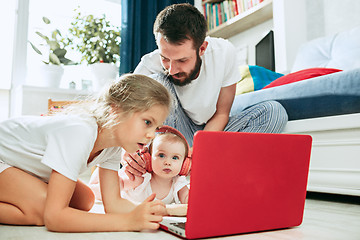 Image showing father and his daughters at home