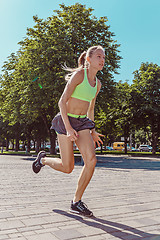 Image showing Pretty sporty woman jogging at city