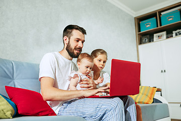 Image showing father and his daughters at home