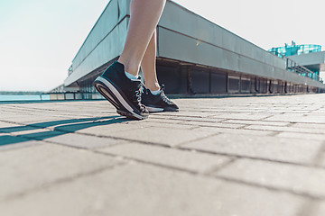 Image showing Pretty sporty woman jogging at city