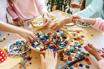 Image showing mosaic puzzle art for kids, children\'s creative game. two sisters are playing mosaic