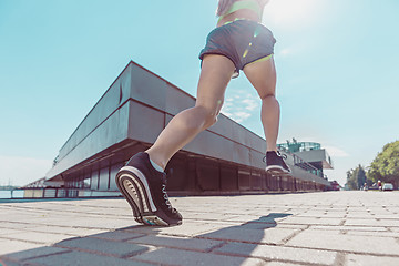 Image showing Pretty sporty woman jogging at city