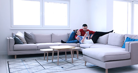 Image showing couple relaxing at  home with tablet computers