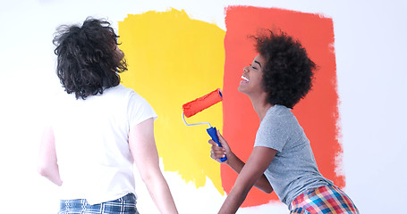 Image showing multiethnic couple painting interior wall