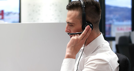 Image showing male call centre operator doing his job