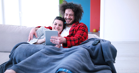 Image showing couple relaxing at  home with tablet computers