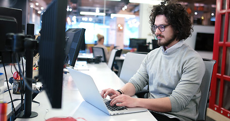 Image showing businessman working using a laptop in startup office