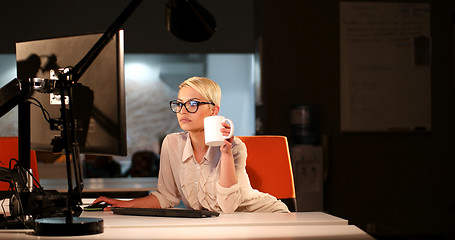 Image showing woman working on computer in dark office