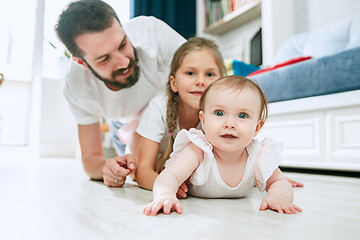 Image showing Proud father holding his newborn baby daughter at home