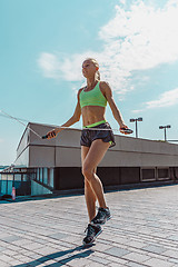 Image showing Fit fitness woman doing fitness exercises outdoors