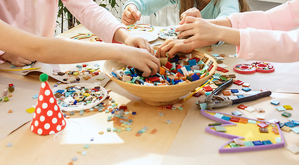 Image showing mosaic puzzle art for kids, children\'s creative game. two sisters are playing mosaic