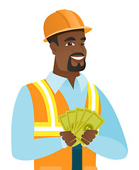 Image showing Young african-american builder holding money.