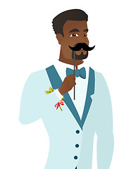 Image showing Young african-american groom with a fake mustache.