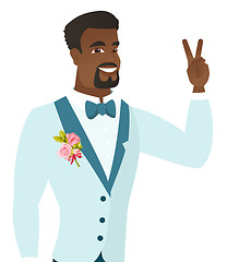 Image showing Young african groom showing the victory gesture.