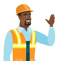 Image showing Young african-american builder waving his hand.