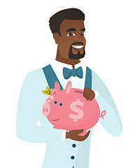 Image showing African-american groom holding a piggy bank.