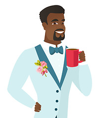 Image showing Young african-american groom holding cup of coffee