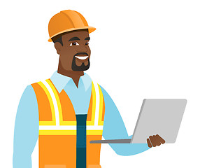 Image showing African-american builder using laptop.