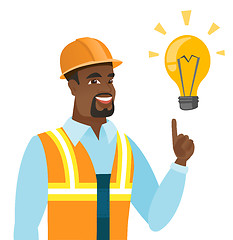 Image showing African-american builder pointing at light bulb.
