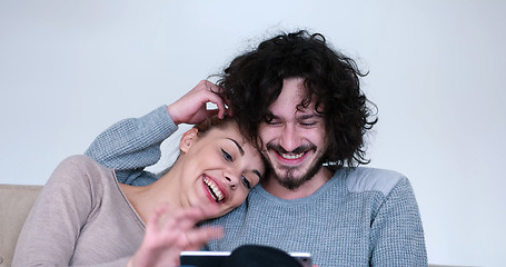 Image showing couple relaxing at  home with tablet computers