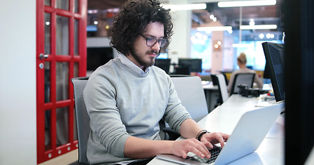 Image showing businessman working using a laptop in startup office