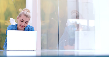 Image showing young women using laptop computer on the floor