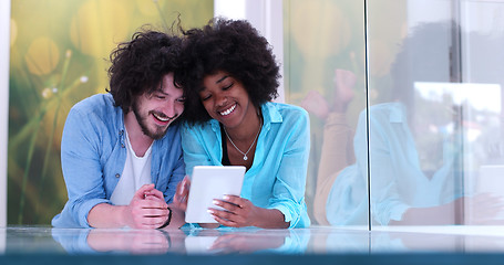 Image showing Couple relaxing together at home with tablet computer