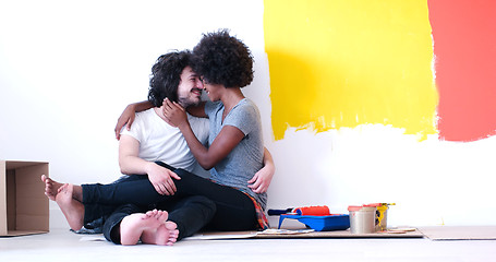 Image showing young multiethnic couple relaxing after painting